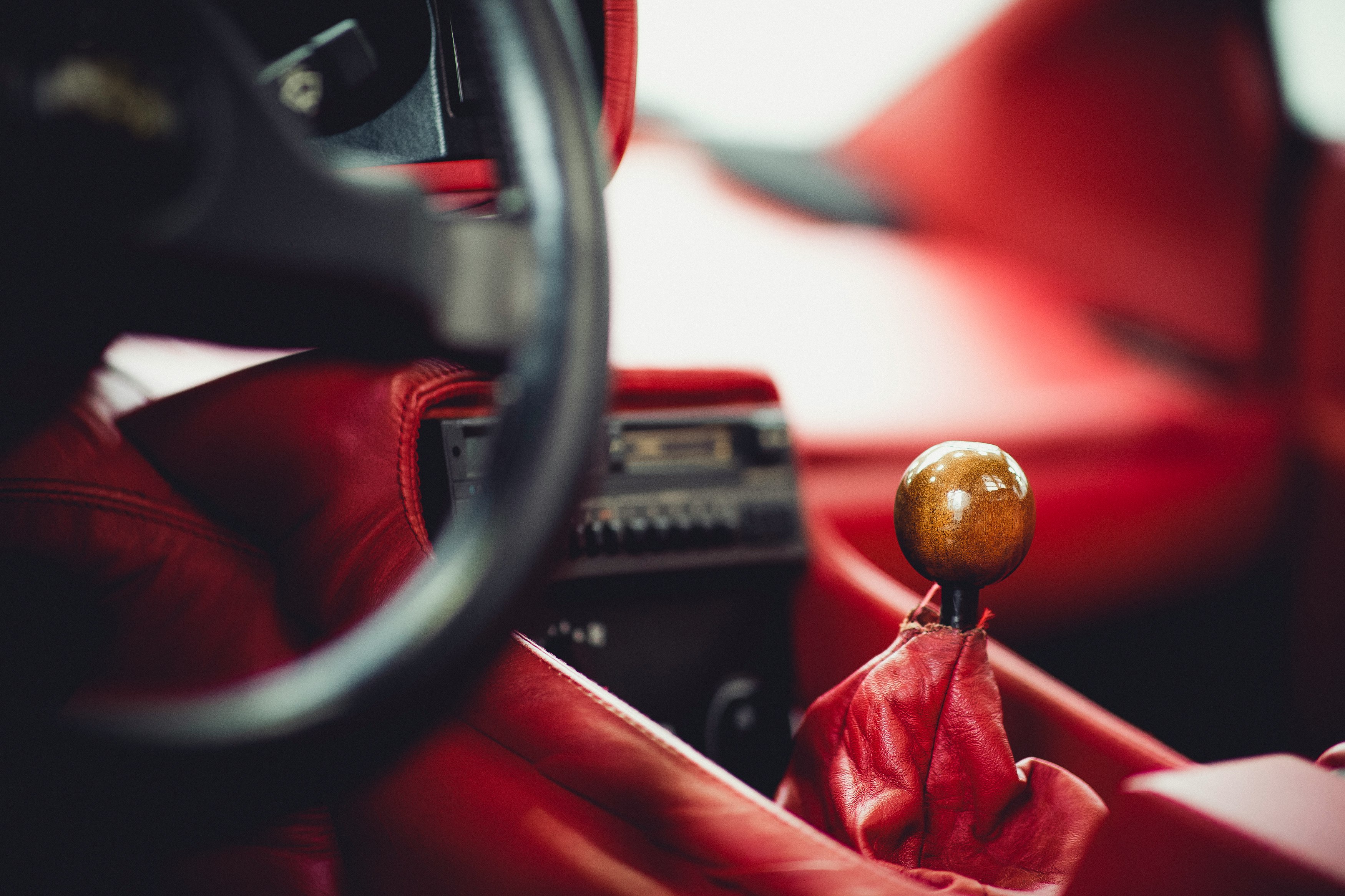 red and gold christmas bauble on car steering wheel